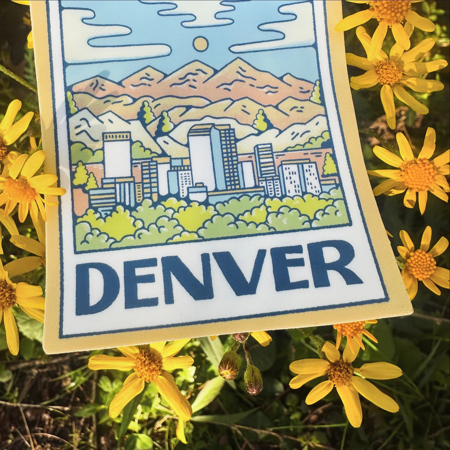 Sticker of Denver with cityscape and mountains surrounded by yellow flowers