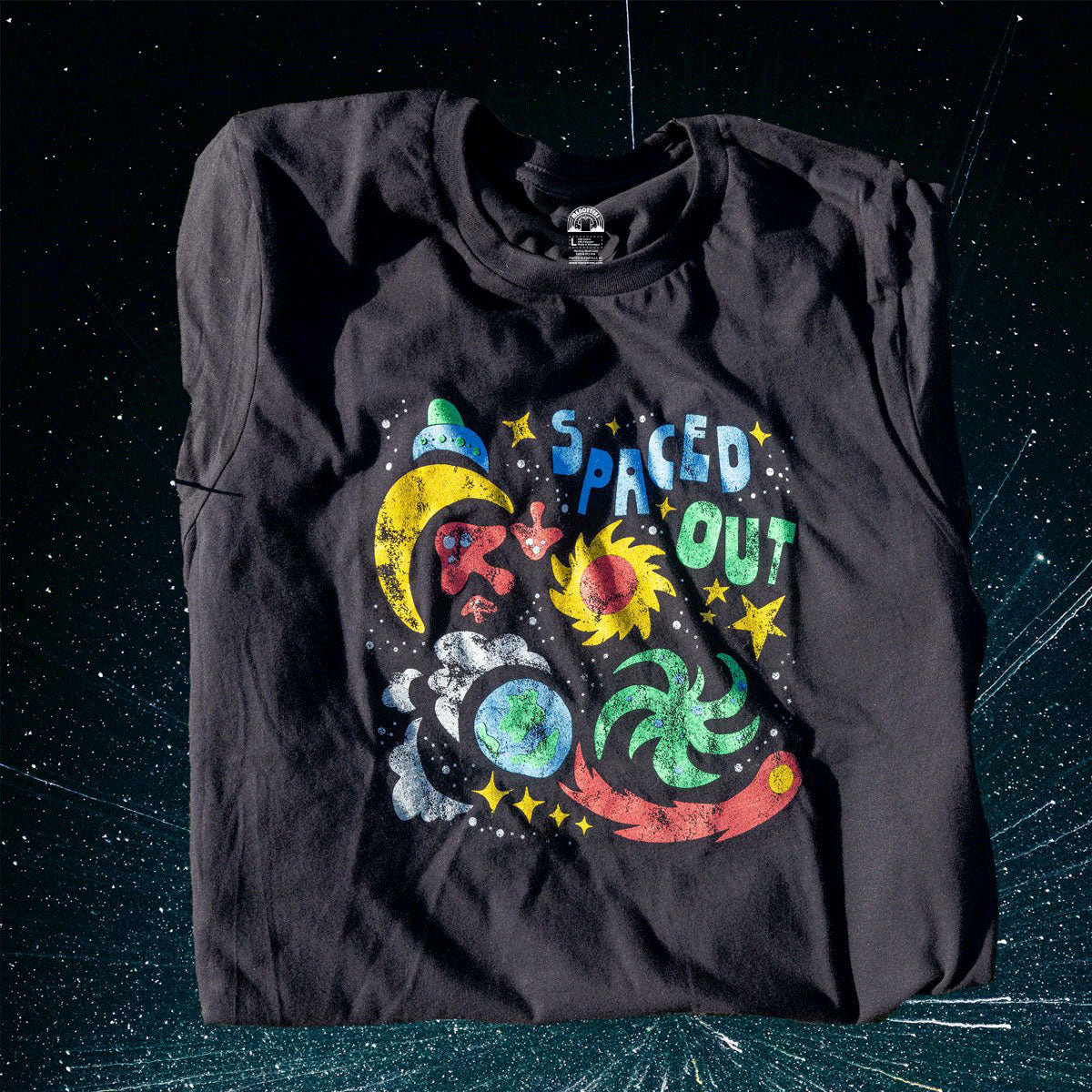 Flatlay of black Spaced Out t-shirt with retro space-themed design