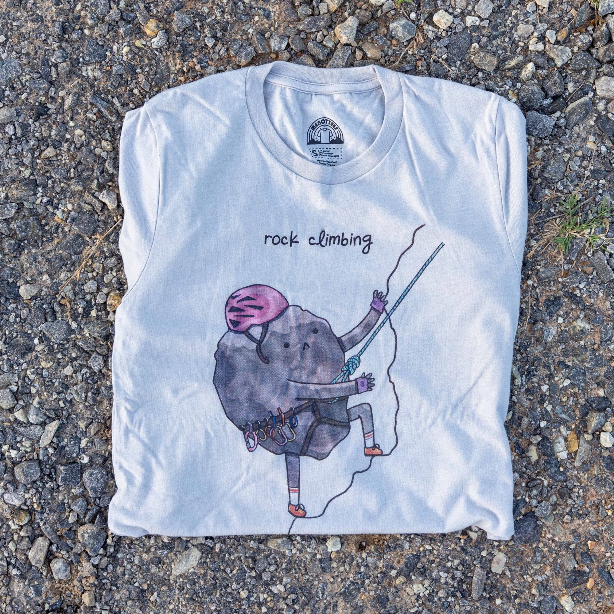 Rock Climbing graphic t-shirt featuring a cartoon rock climbing up a cliff. Unisex fit, soft cotton blend.