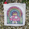 White pouch with a colorful mushroom and rainbow design on a natural background