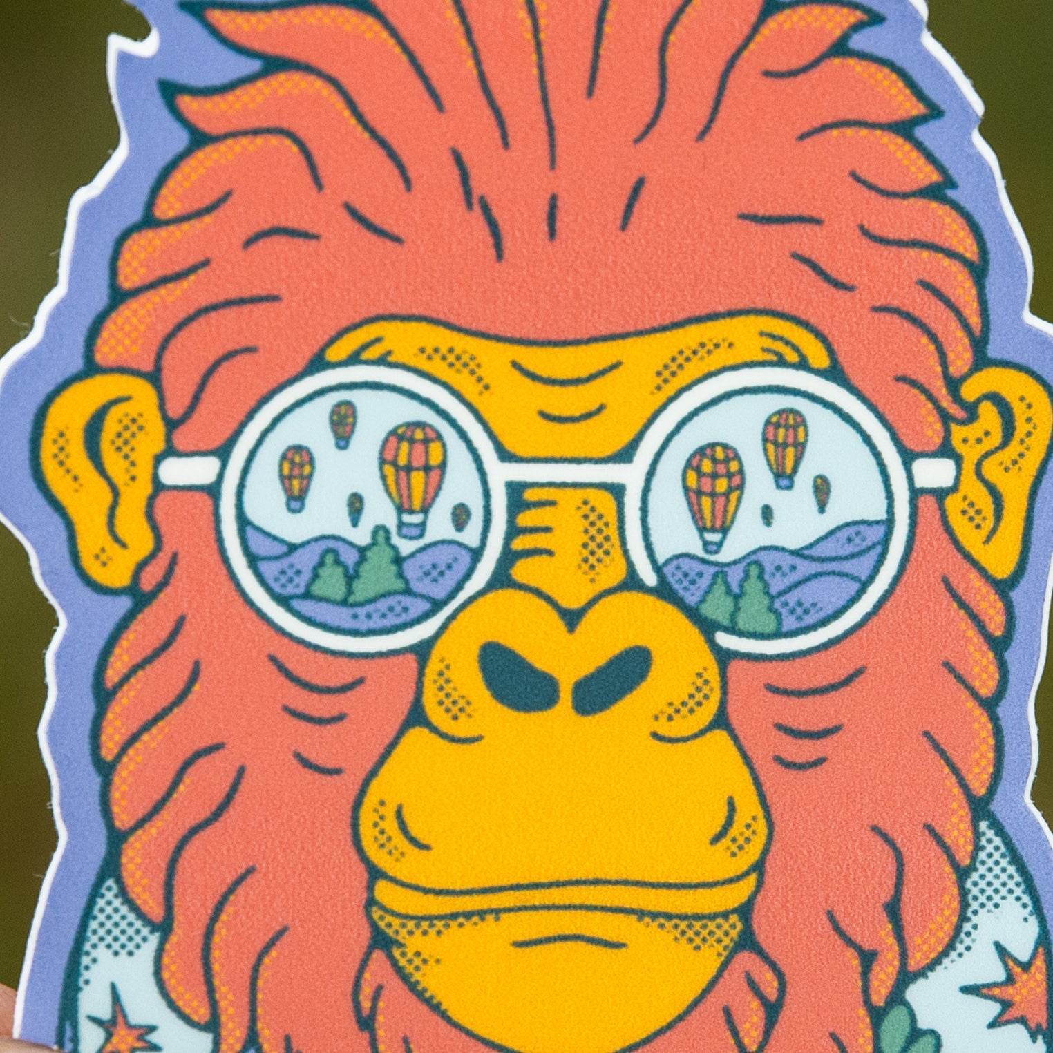 Zoomed-in view of the Bigfoot sticker’s face, highlighting the balloon sunglasses and detailed scarf design.

