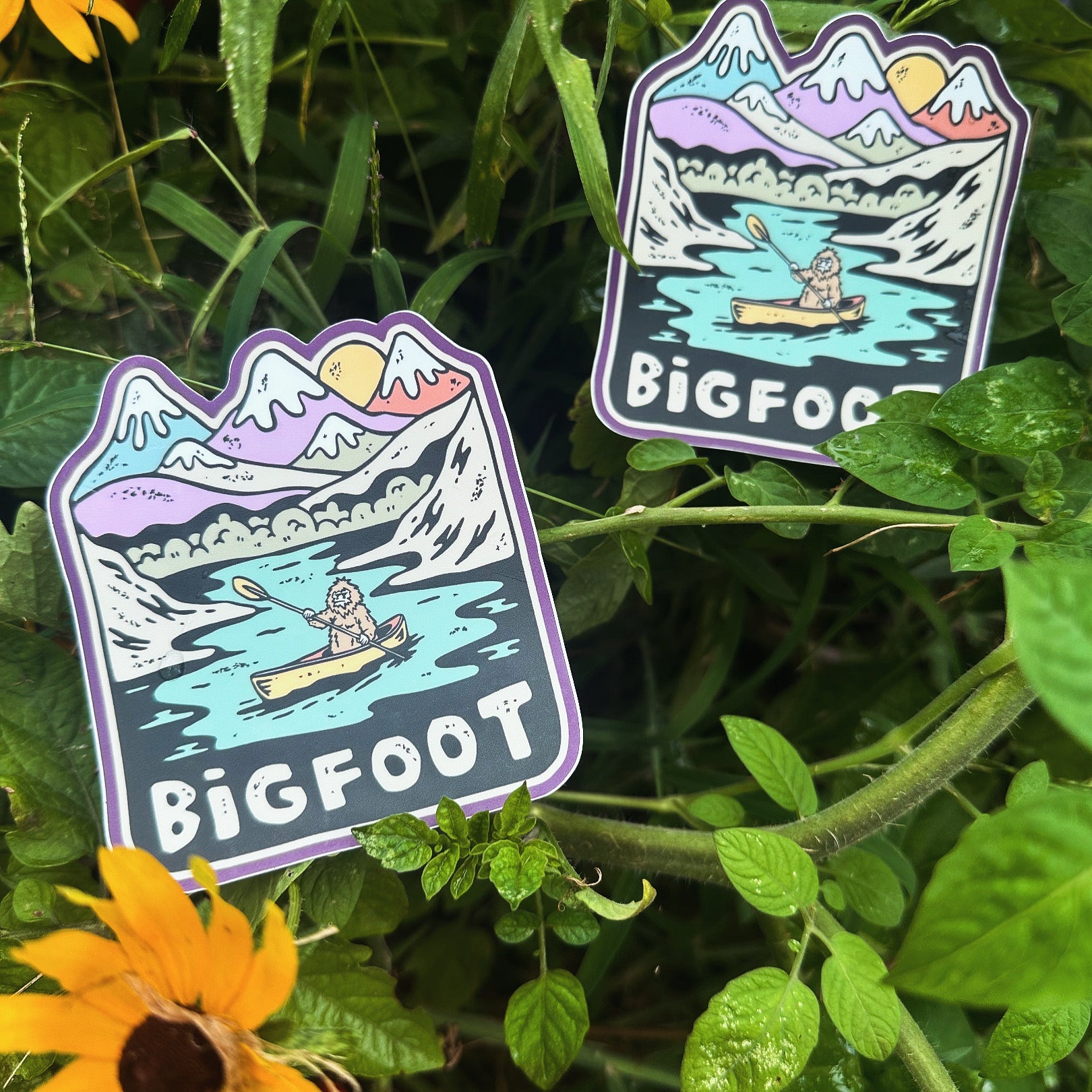 Sticker resting in a bed of yellow wildflowers, highlighting its outdoor adventure theme.

