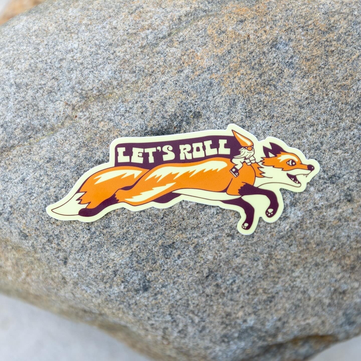 Sticker placed on textured stone or concrete surface for scale

