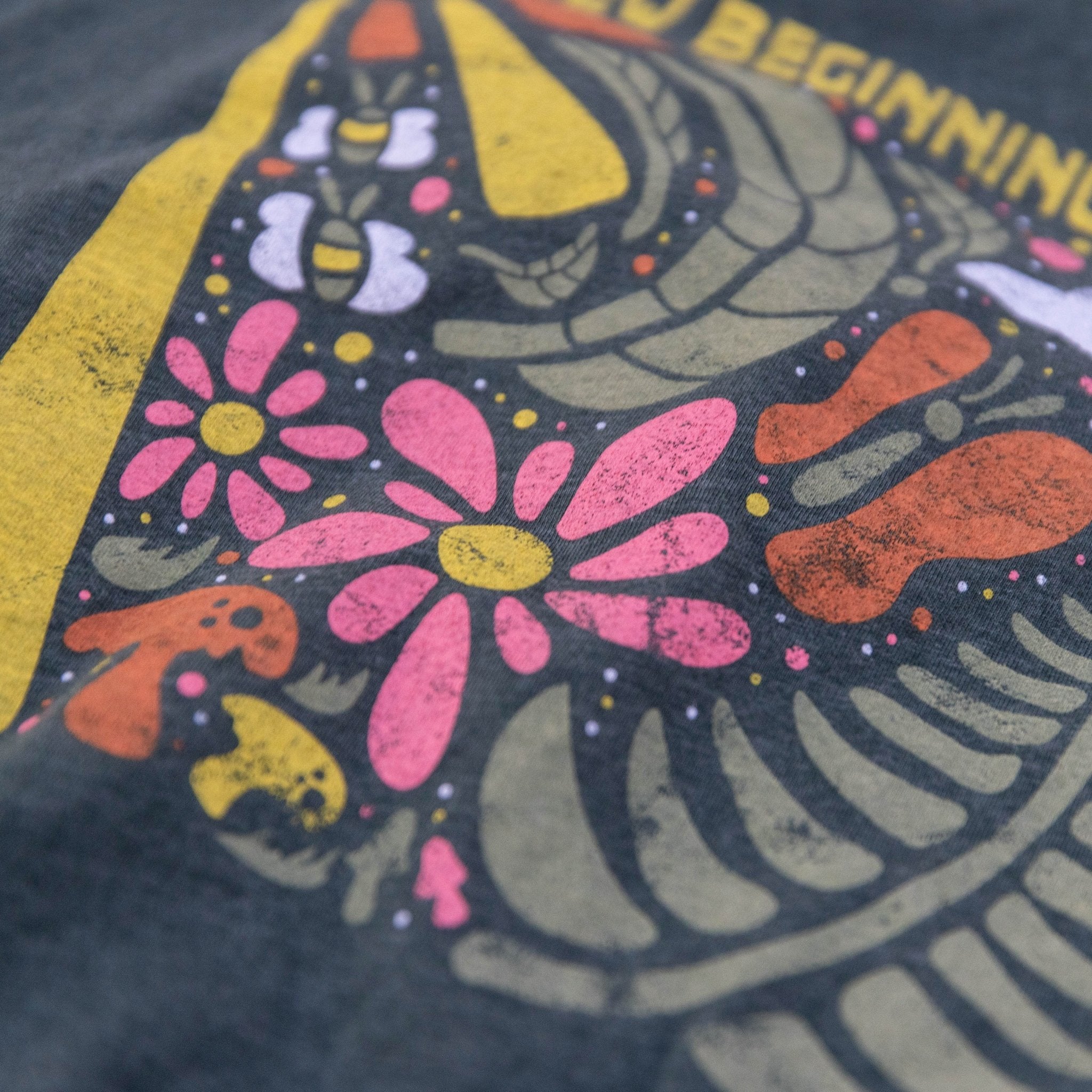 Close-up of New Beginnings artwork on soft cotton blend shirt