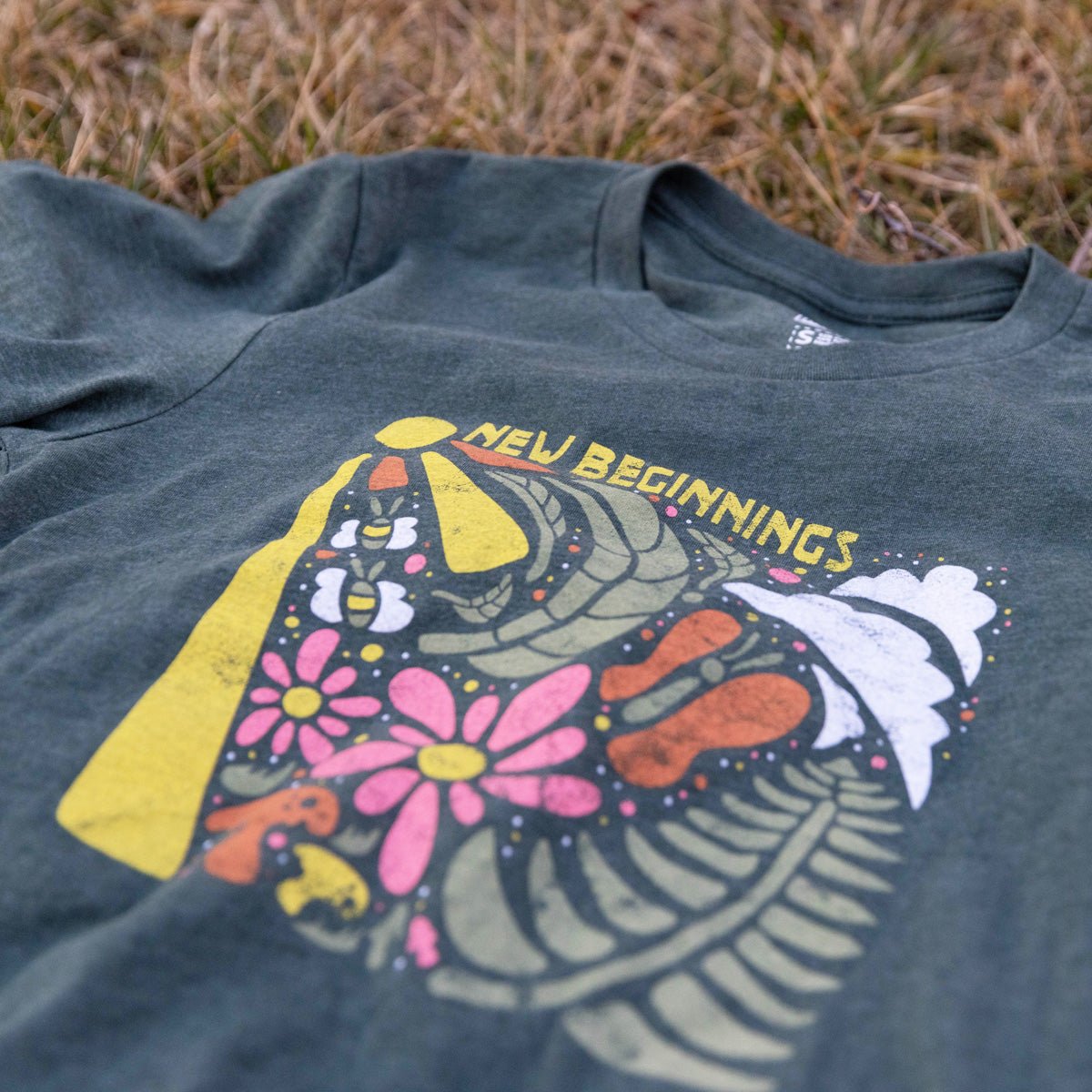 Close-up of New Beginnings artwork on soft cotton blend shirt