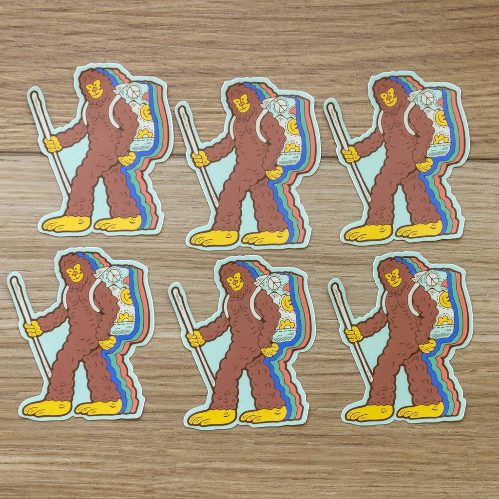 Multiple Retro Hiking Bigfoot stickers arranged flat, showing repeated colorful design.

