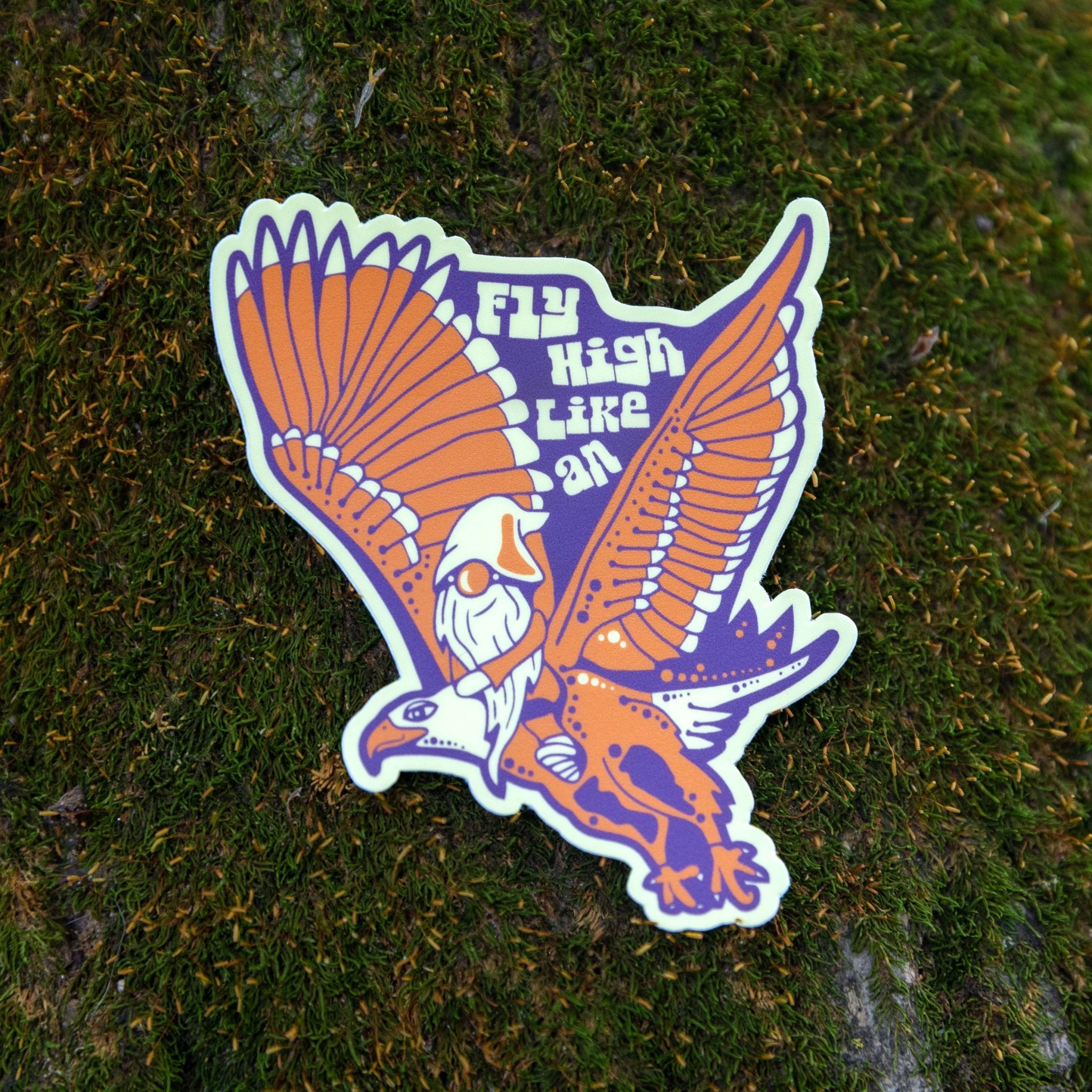 Close-up of sticker laying on grass or textured surface


