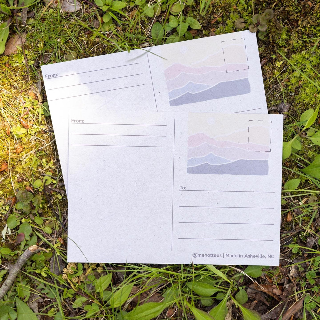 Postcard laying flat outdoors with bright color details visible


