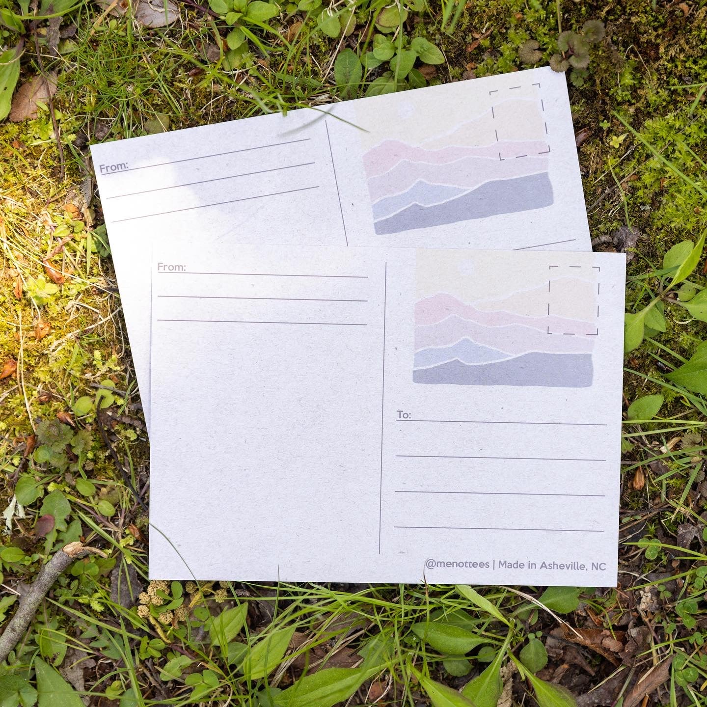 Postcard laying flat outdoors with bright color details visible

