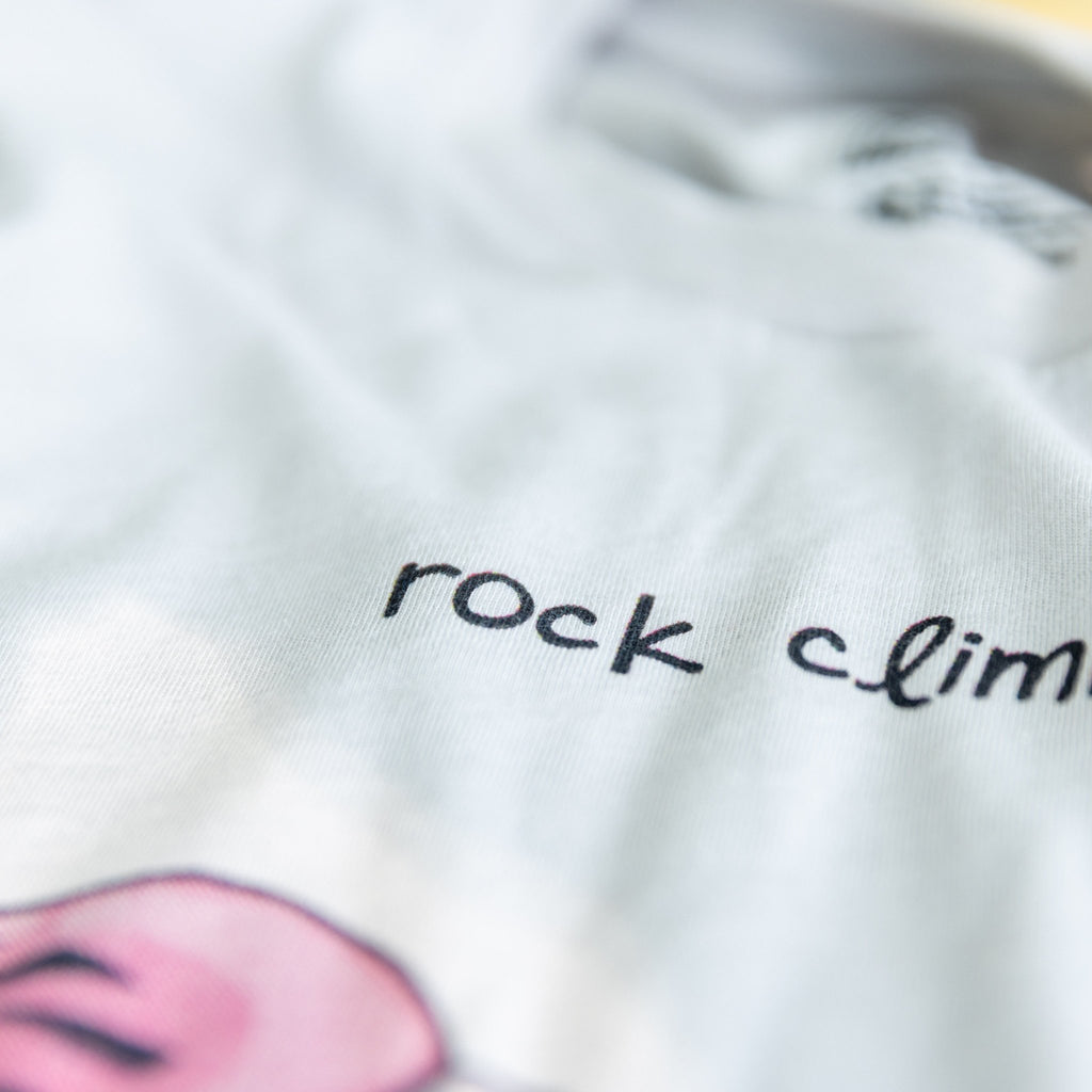 Close-up of Rock Climbing shirt artwork. Funny cartoon of a determined rock scaling a cliff.