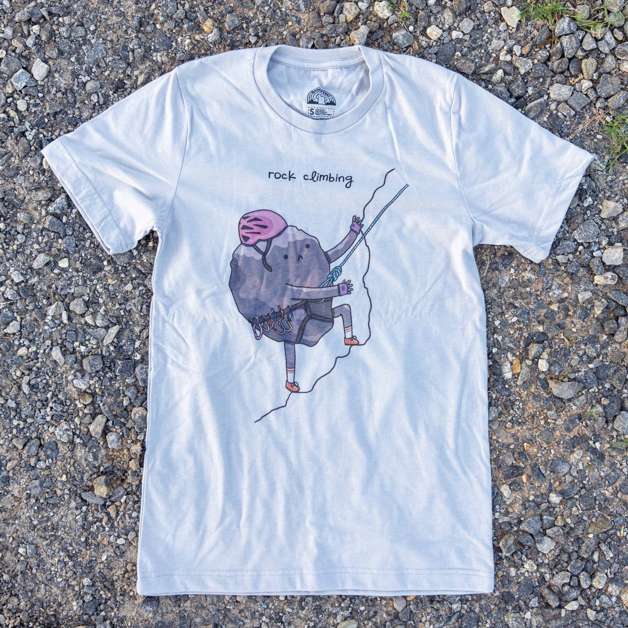 Rock Climbing graphic t-shirt featuring a cartoon rock climbing up a cliff. Unisex fit, soft cotton blend.