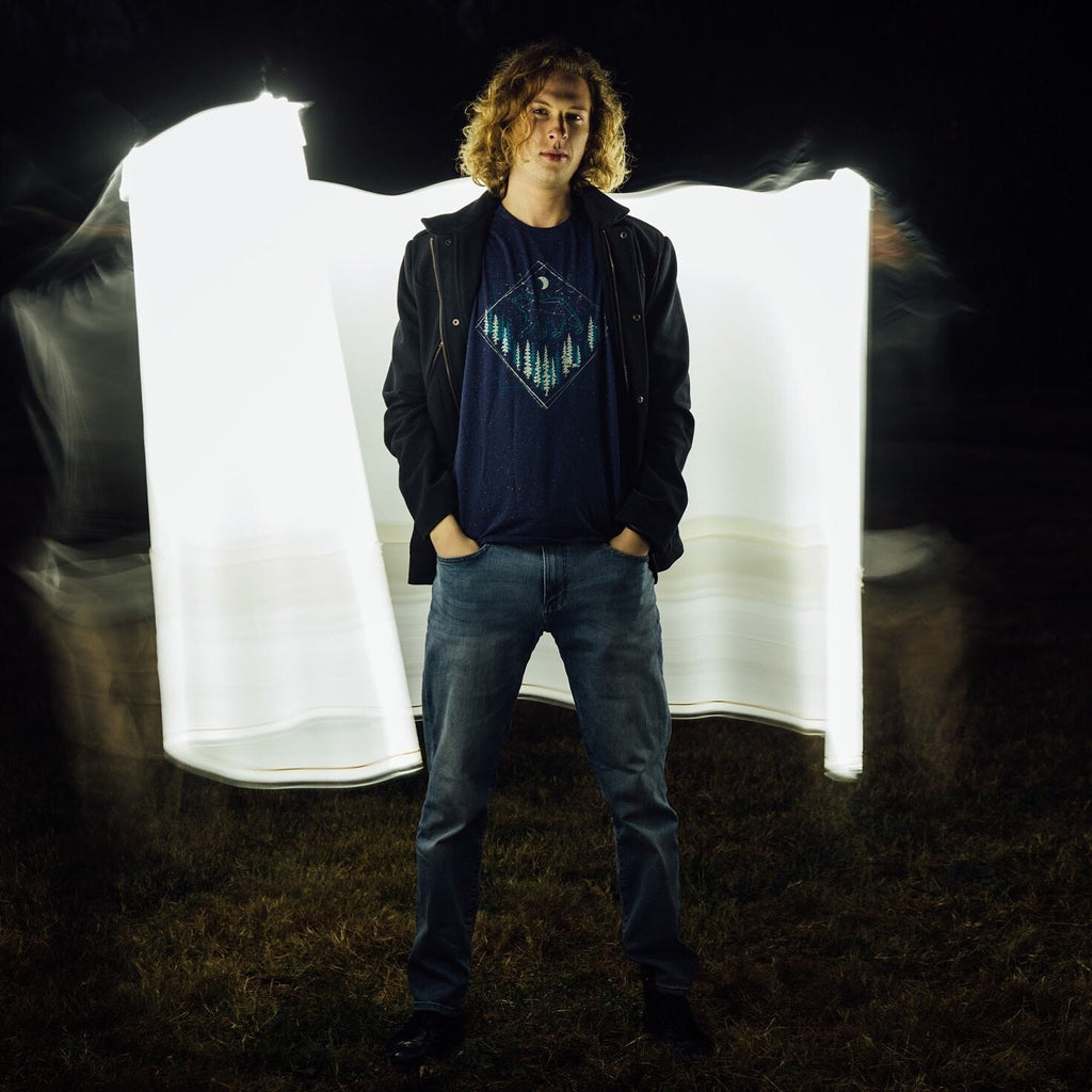 Model standing with arms relaxed, showing full shirt design

