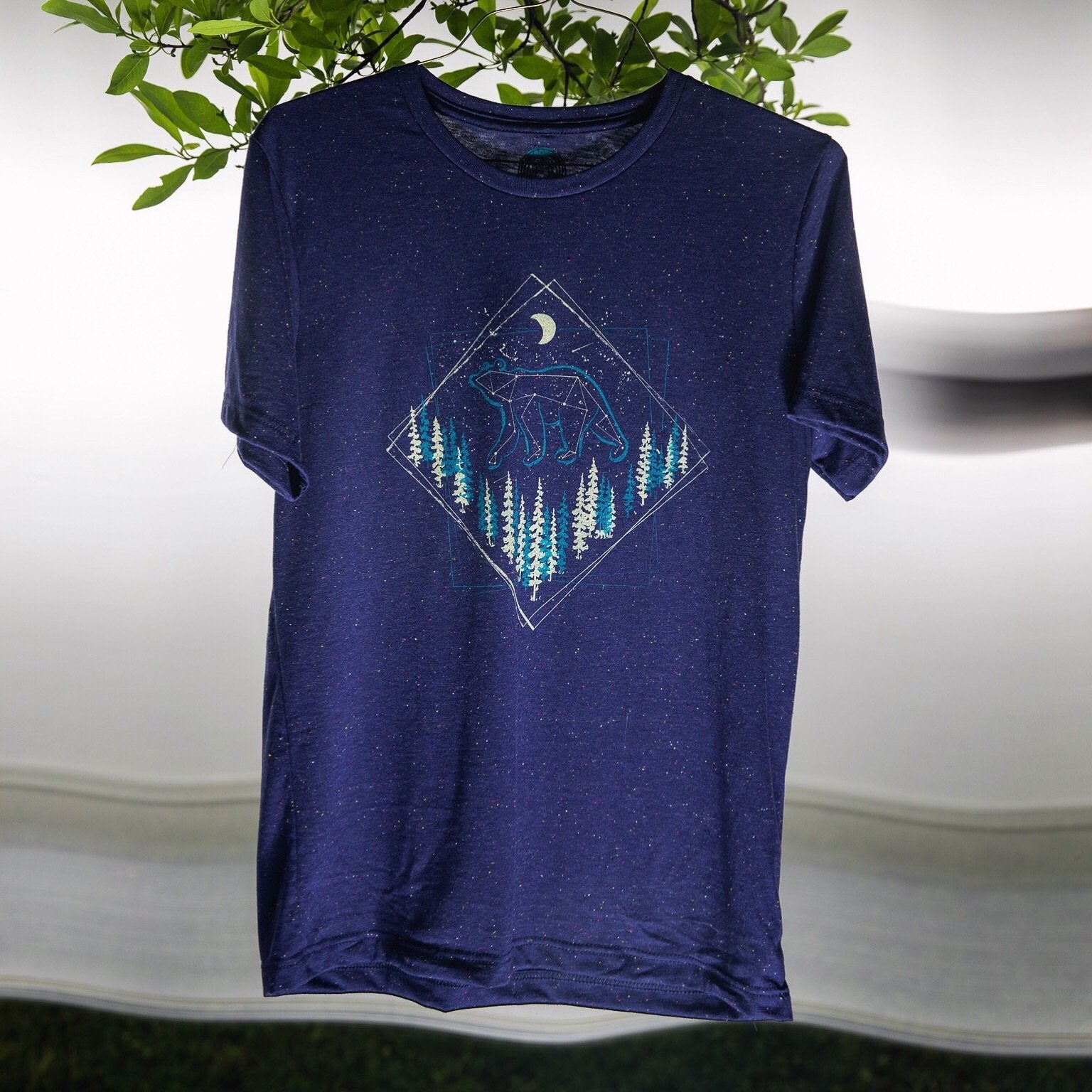 T-shirt hanging with clear view of celestial bear design

